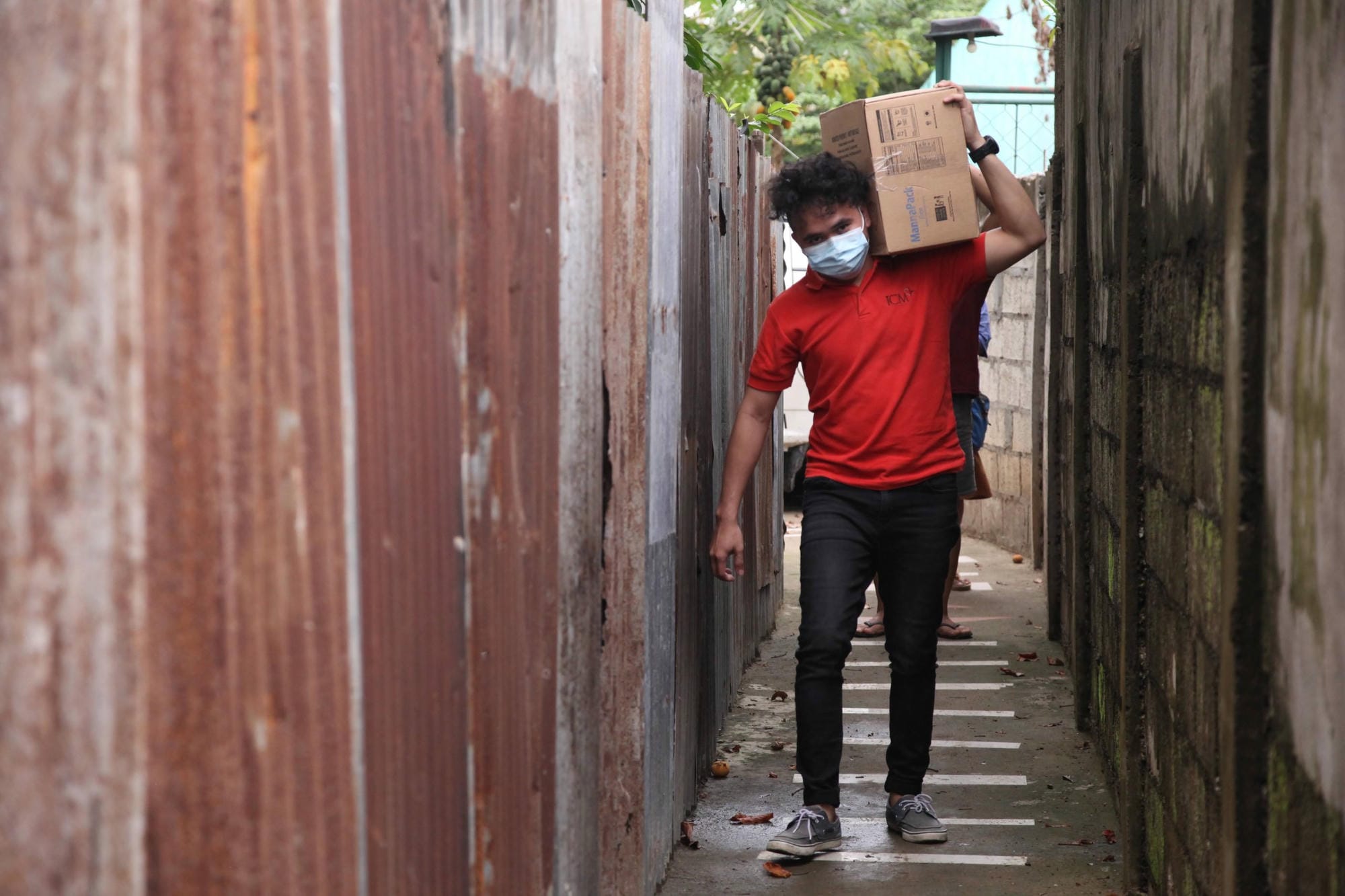 ICM staff in Cebu bring food packs to the city's urban poor