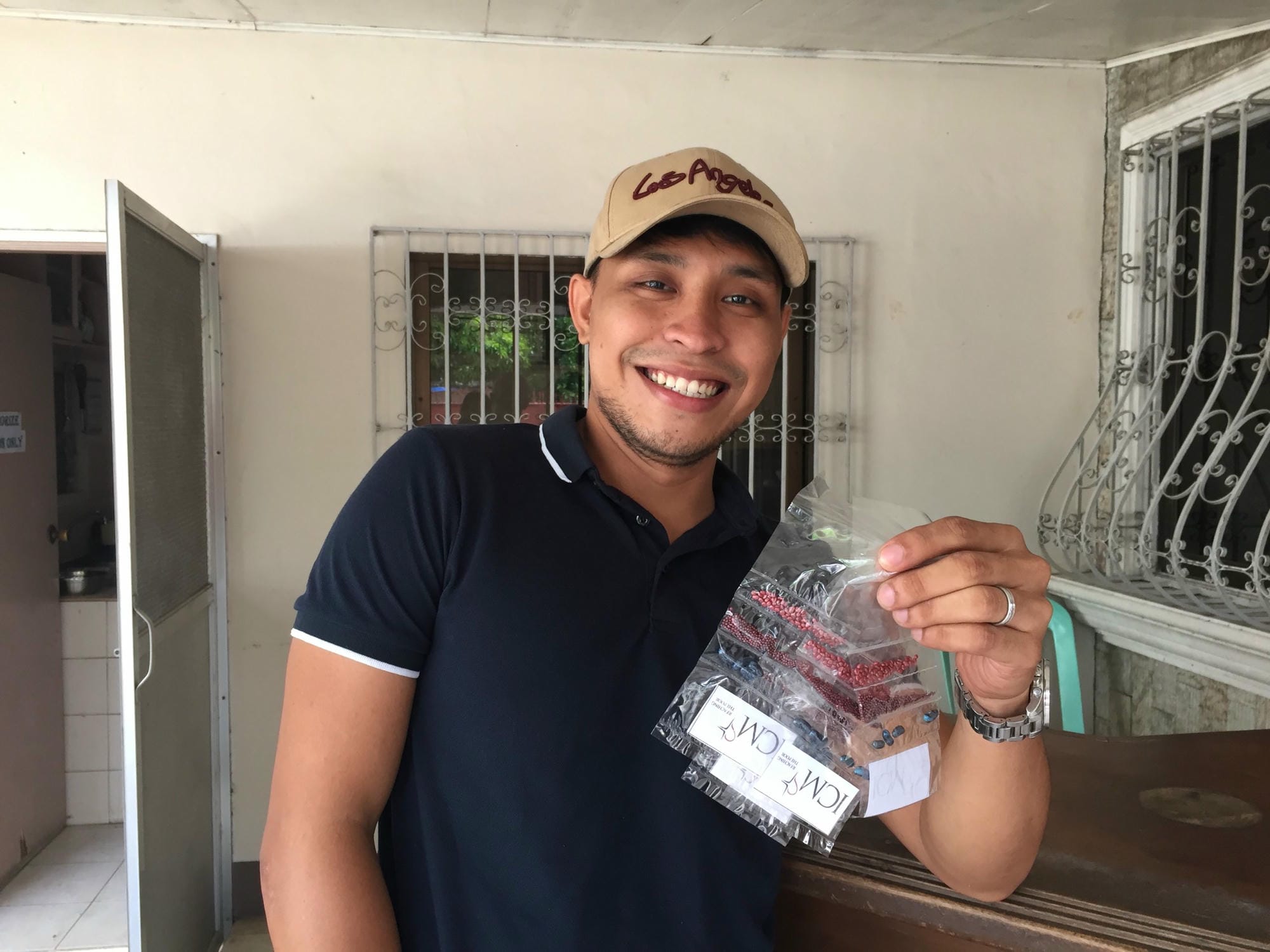 ICM's livelihood coordinator, Aldran, holds up the seeds to be distributed in his community