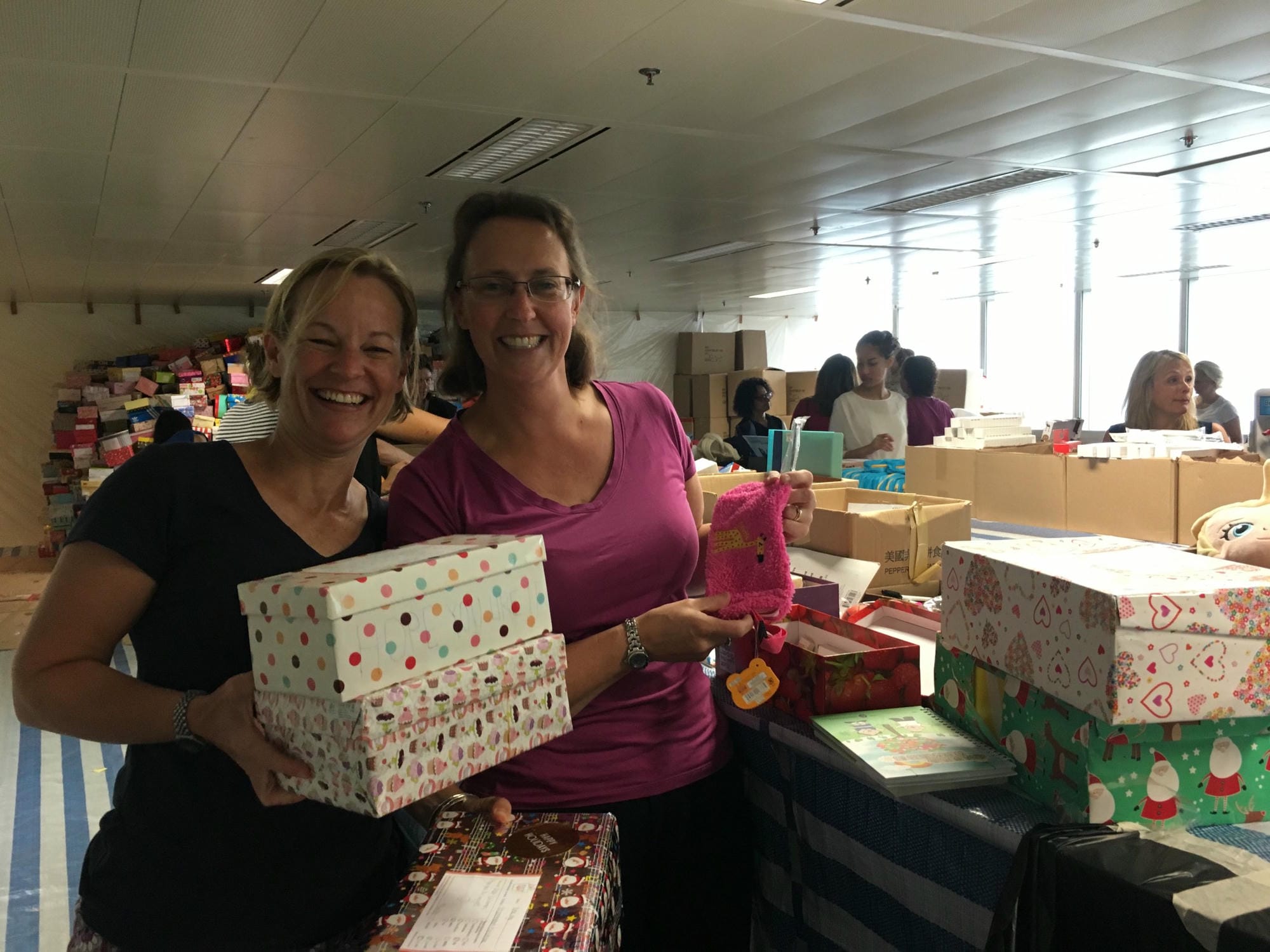 Hardworking Kellett mums Lucy Wilkinson and Amanda Dijanosic check boxes. 