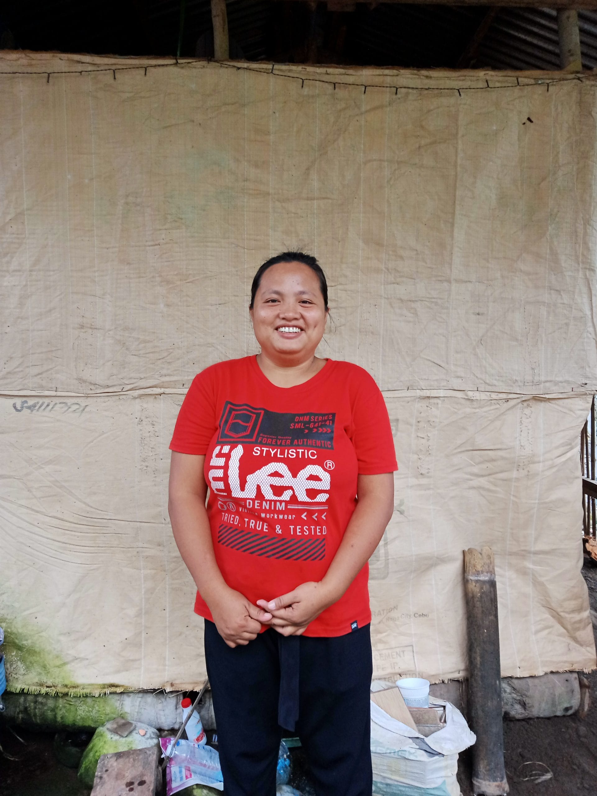 Jill standing in front of her house_International Care Ministries