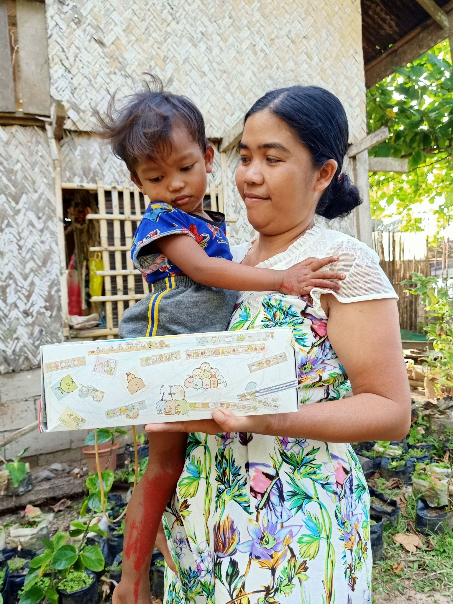 CJ and Bernalyn, holding a Box of Hope